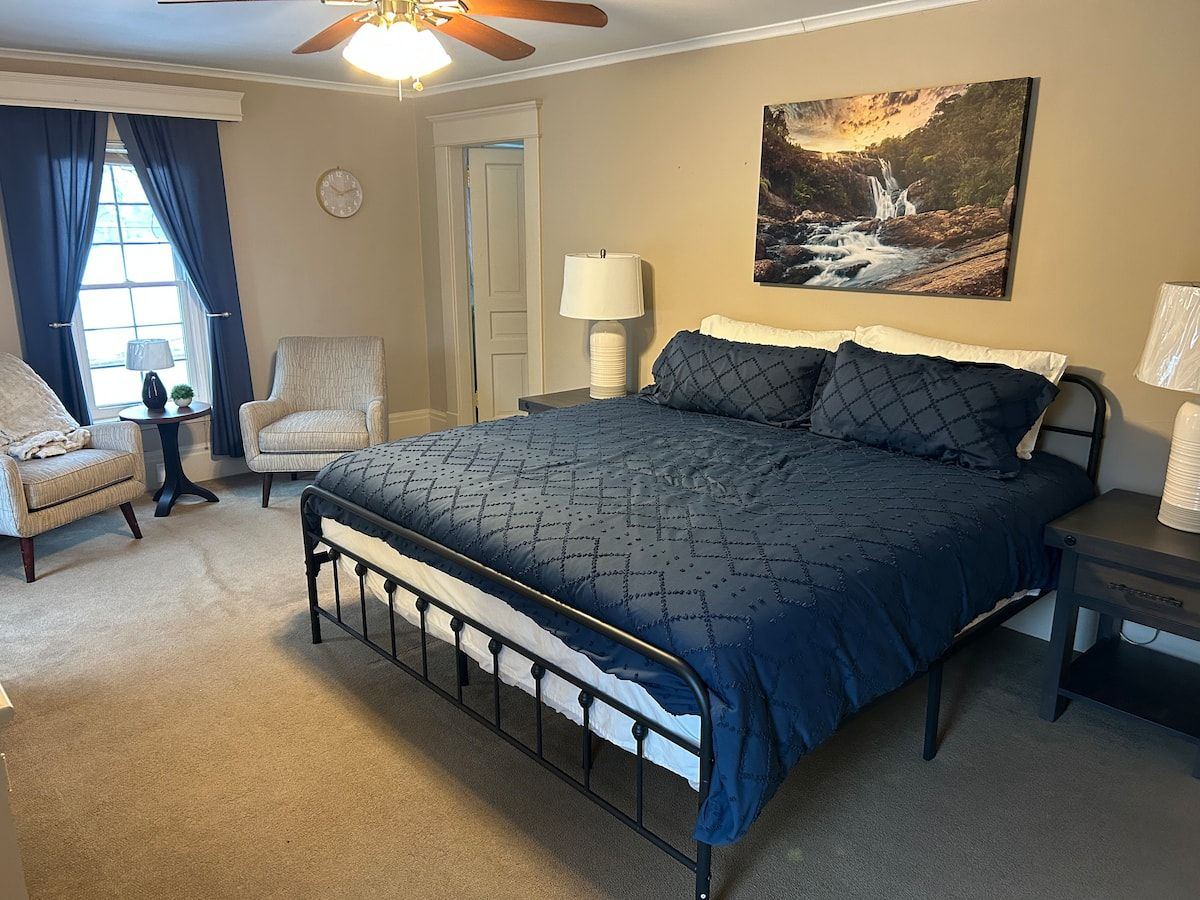 Primary bedroom in the Windmill House with a king bed